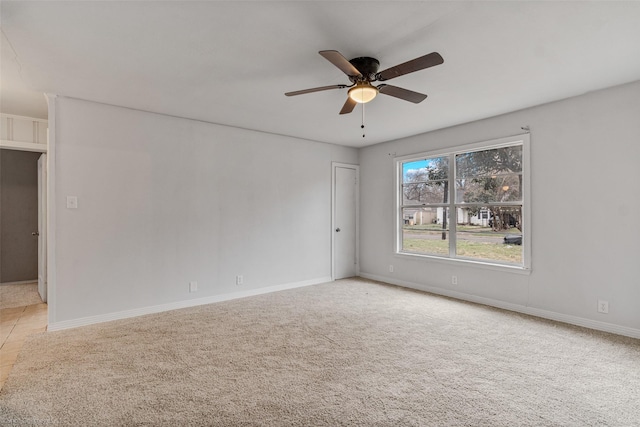 carpeted spare room featuring ceiling fan