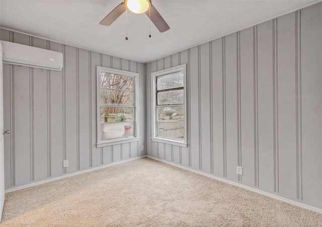 spare room featuring a wall mounted AC, hardwood / wood-style flooring, and ceiling fan