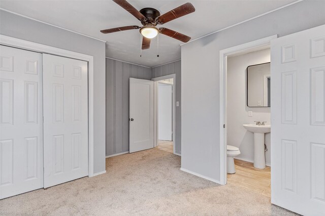 unfurnished bedroom featuring a closet, ceiling fan, and hardwood / wood-style floors