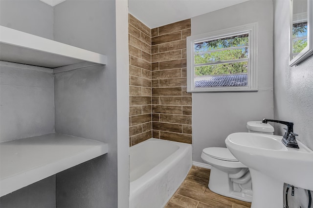 bathroom featuring wood-type flooring, toilet, and  shower combination