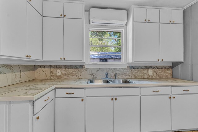 kitchen with light tile patterned flooring, tasteful backsplash, ceiling fan, white cabinets, and sink