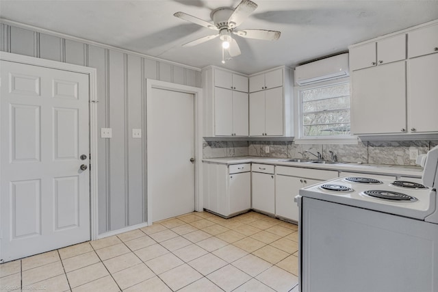 kitchen with white cabinetry, sink, a wall mounted AC, and white range with electric cooktop