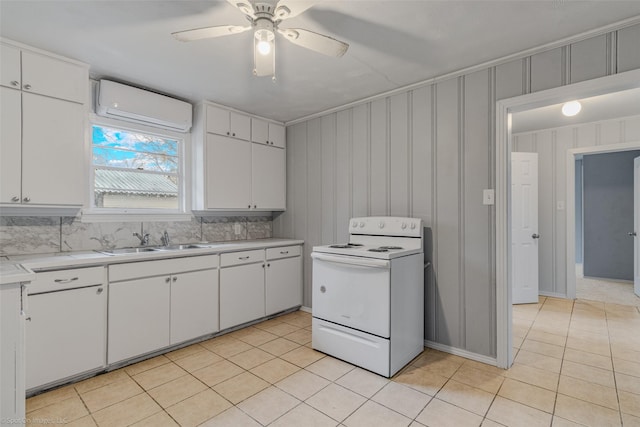 kitchen featuring white cabinets, sink, electric range, and a wall unit AC