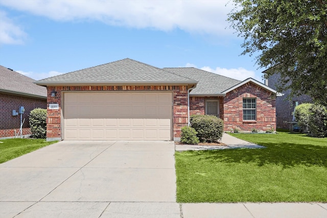 single story home featuring a garage and a front lawn