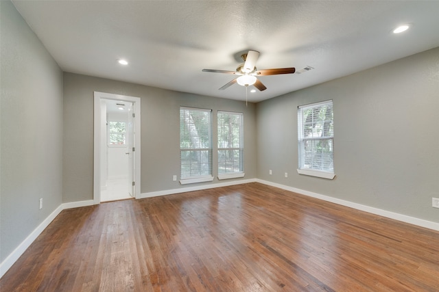 spare room featuring wood-type flooring and ceiling fan