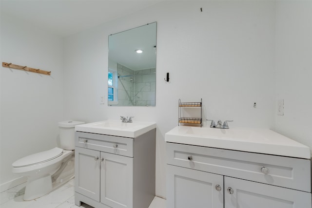 bathroom featuring a tile shower, vanity, and toilet