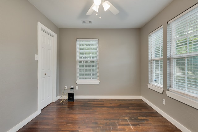 spare room with ceiling fan and dark wood-type flooring