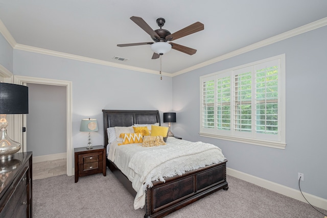 carpeted bedroom featuring visible vents, crown molding, baseboards, and ceiling fan