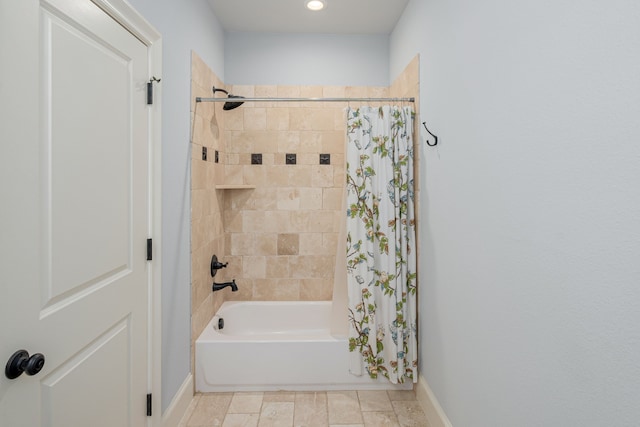 full bath with shower / tub combo and baseboards