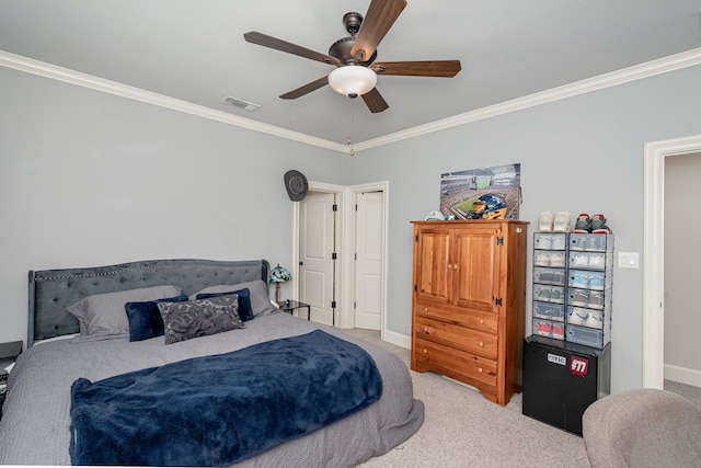 bedroom featuring ornamental molding, light carpet, visible vents, and a ceiling fan