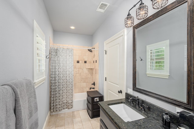 bathroom with baseboards, visible vents, shower / bath combo with shower curtain, and vanity