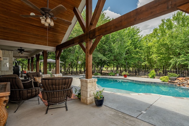 view of swimming pool with ceiling fan, fence, a fenced in pool, and a patio