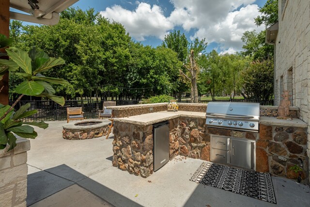 view of patio featuring area for grilling and a fire pit