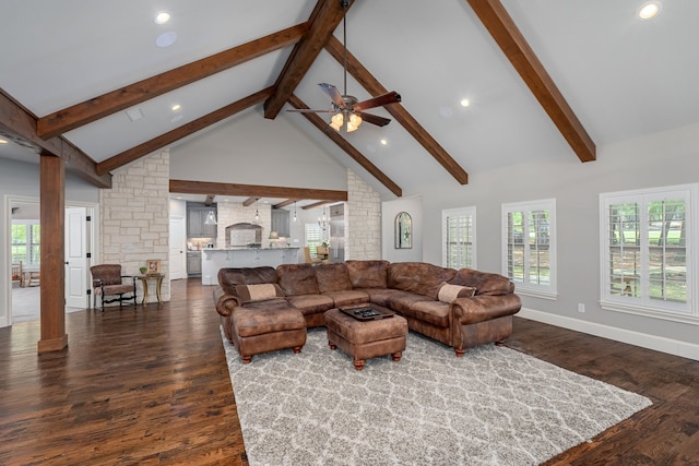 living area with dark wood-style floors, high vaulted ceiling, beam ceiling, and decorative columns