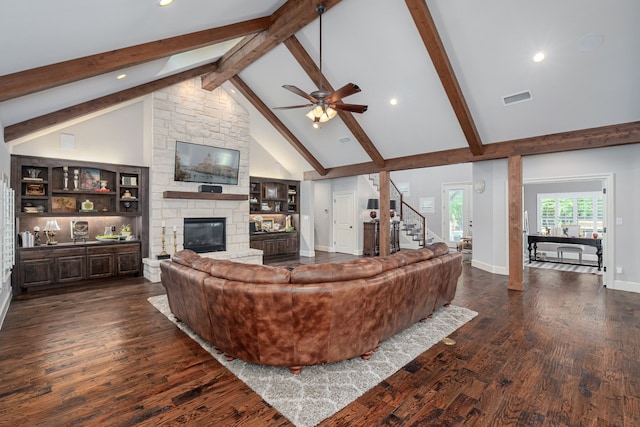 living room featuring wood-type flooring, a fireplace, ceiling fan, high vaulted ceiling, and beamed ceiling