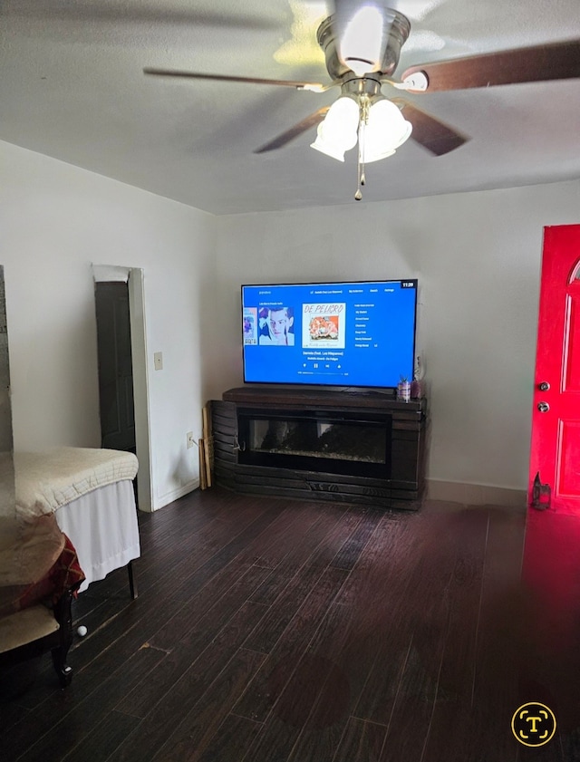 living room featuring wood-type flooring and ceiling fan