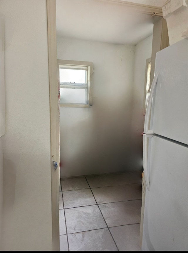 kitchen featuring light tile patterned flooring and white refrigerator