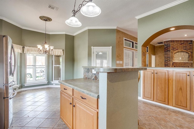 kitchen with light tile patterned floors, a notable chandelier, ornamental molding, and stainless steel refrigerator with ice dispenser