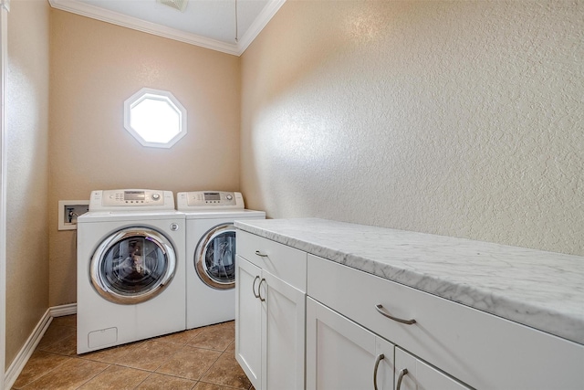 laundry room with light tile patterned floors, crown molding, washer and clothes dryer, and cabinets