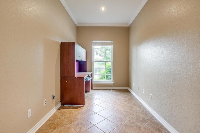 unfurnished office with light tile patterned floors and ornamental molding