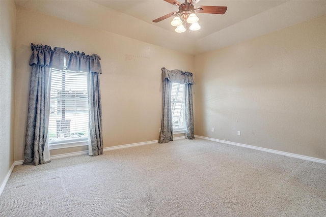 empty room featuring vaulted ceiling, ceiling fan, and carpet