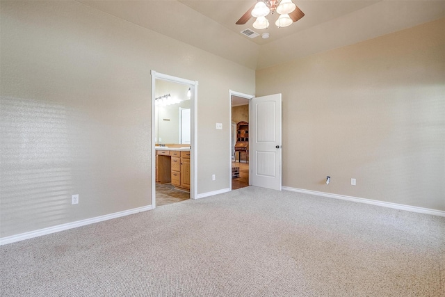 unfurnished bedroom with light carpet, connected bathroom, and ceiling fan