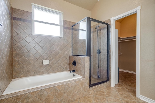 bathroom with independent shower and bath and tile patterned flooring