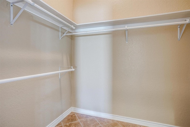 spacious closet featuring tile patterned flooring