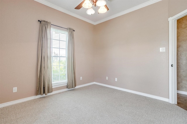 spare room featuring crown molding, carpet flooring, and ceiling fan