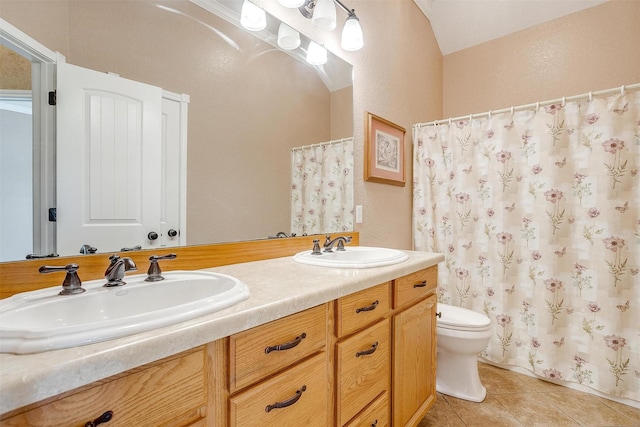 bathroom featuring vanity, tile patterned floors, and toilet