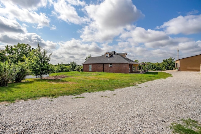 view of side of home featuring a yard