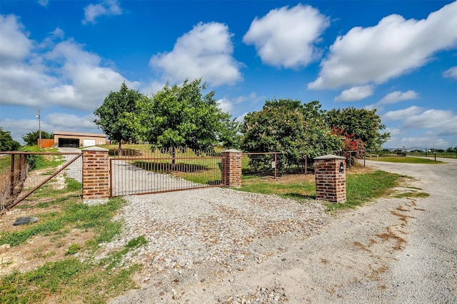 view of gate featuring an outbuilding