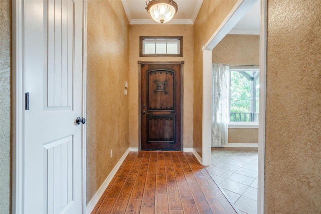 entryway featuring crown molding