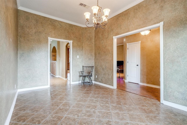 tiled spare room with an inviting chandelier and ornamental molding