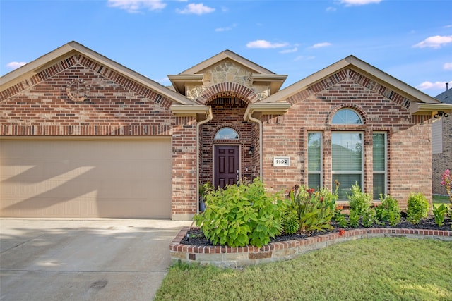 view of property with a garage and a front lawn