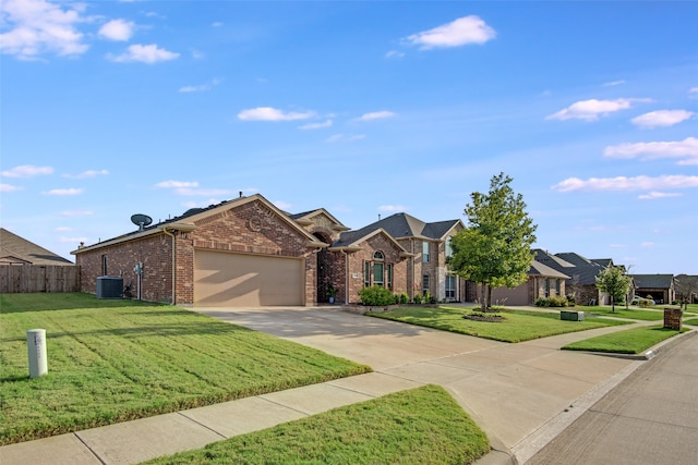 view of front of house featuring a garage, central AC unit, and a front yard