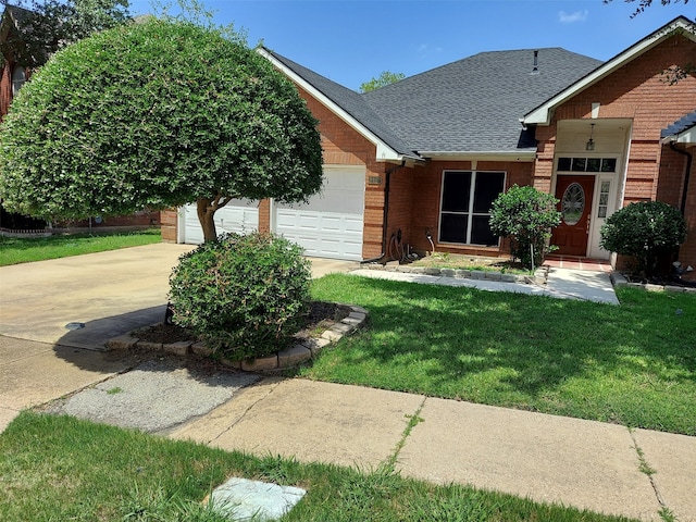 view of front of property featuring a garage and a front yard