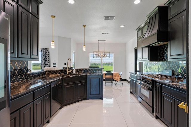 kitchen featuring black dishwasher, pendant lighting, gas range, light tile patterned flooring, and custom range hood