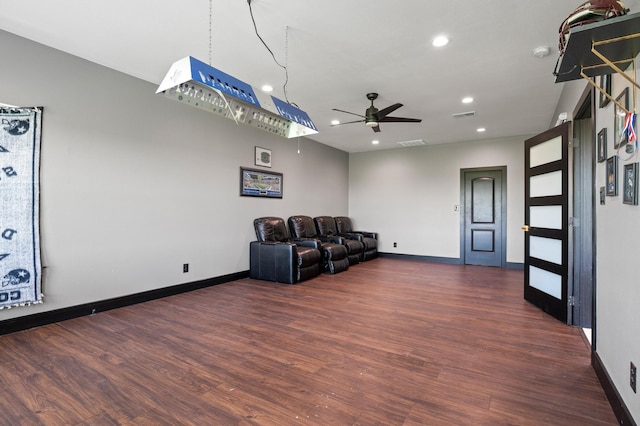 unfurnished living room featuring ceiling fan and dark hardwood / wood-style floors