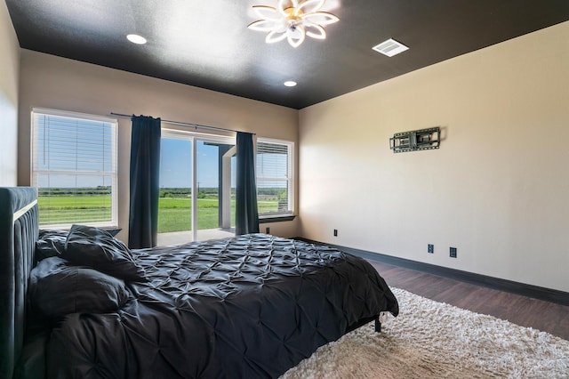 bedroom with dark wood-type flooring