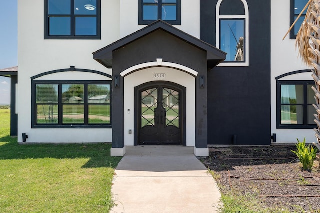 entrance to property featuring a lawn