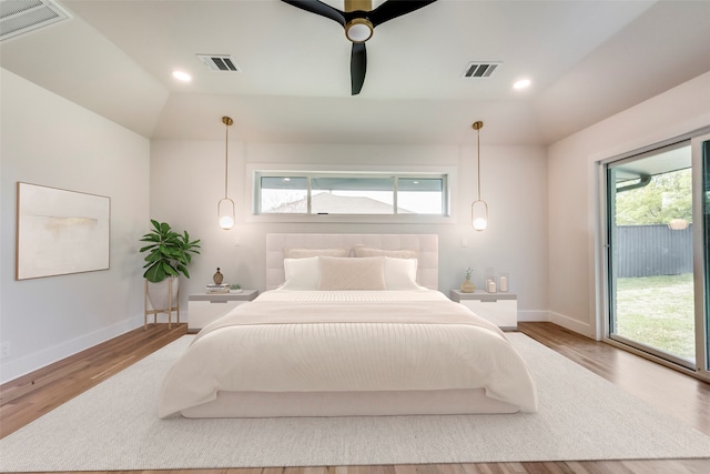 bedroom featuring hardwood / wood-style flooring, lofted ceiling, access to outside, and ceiling fan