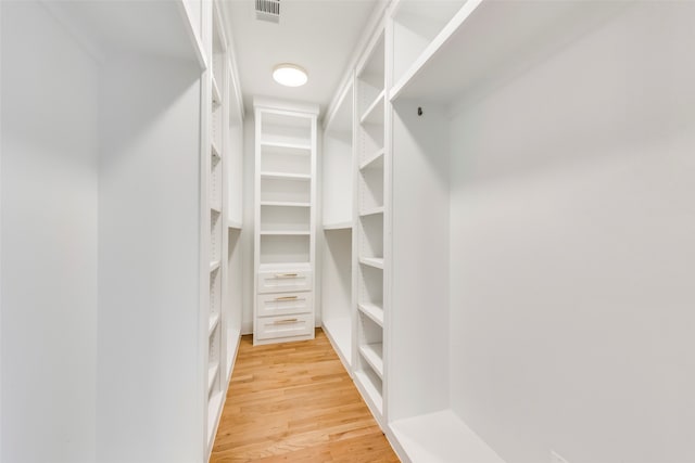 spacious closet featuring light hardwood / wood-style floors