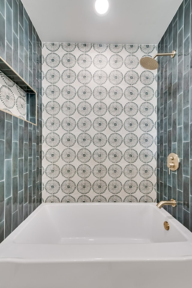 bathroom with tile walls and tiled shower / bath combo