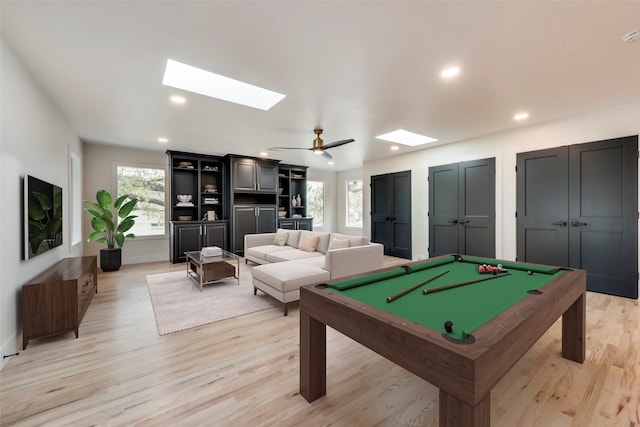 recreation room with a skylight, pool table, light hardwood / wood-style floors, and ceiling fan