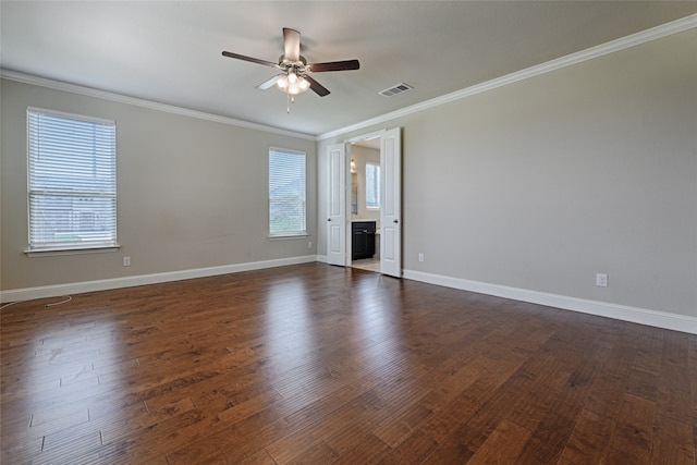 empty room featuring ceiling fan, crown molding, and dark hardwood / wood-style flooring