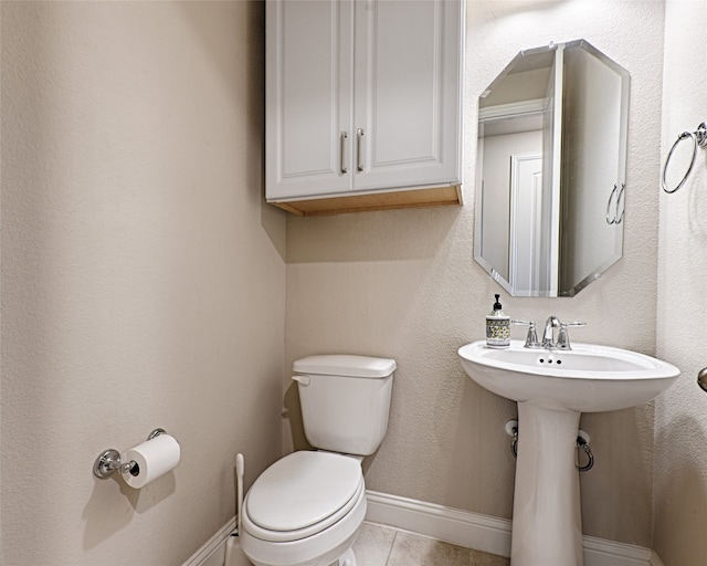 bathroom with toilet and tile patterned flooring