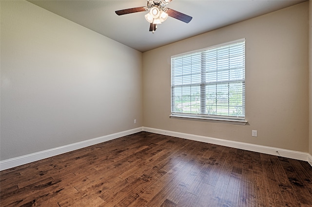 unfurnished room featuring dark wood-type flooring and ceiling fan