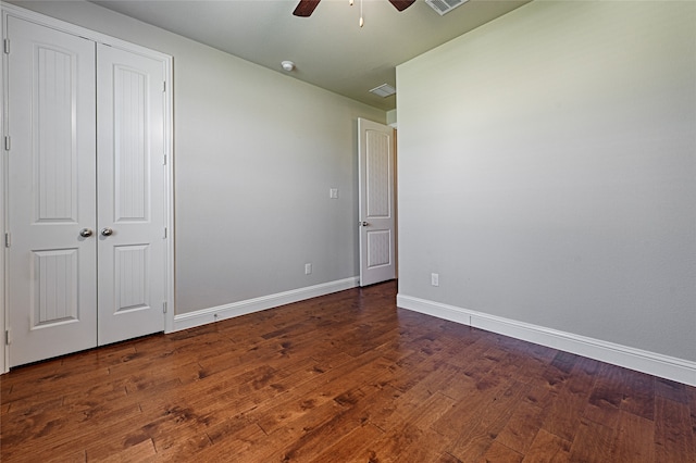 unfurnished bedroom featuring ceiling fan, hardwood / wood-style floors, and a closet