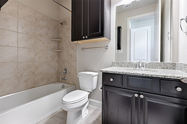 full bathroom featuring vanity, tiled shower / bath combo, toilet, and tile patterned flooring